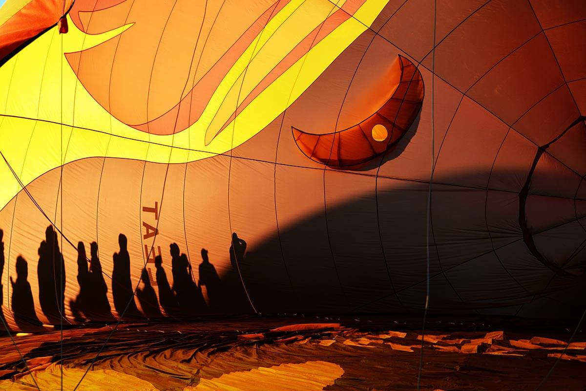 silhouette of people on a hot air balloon at night